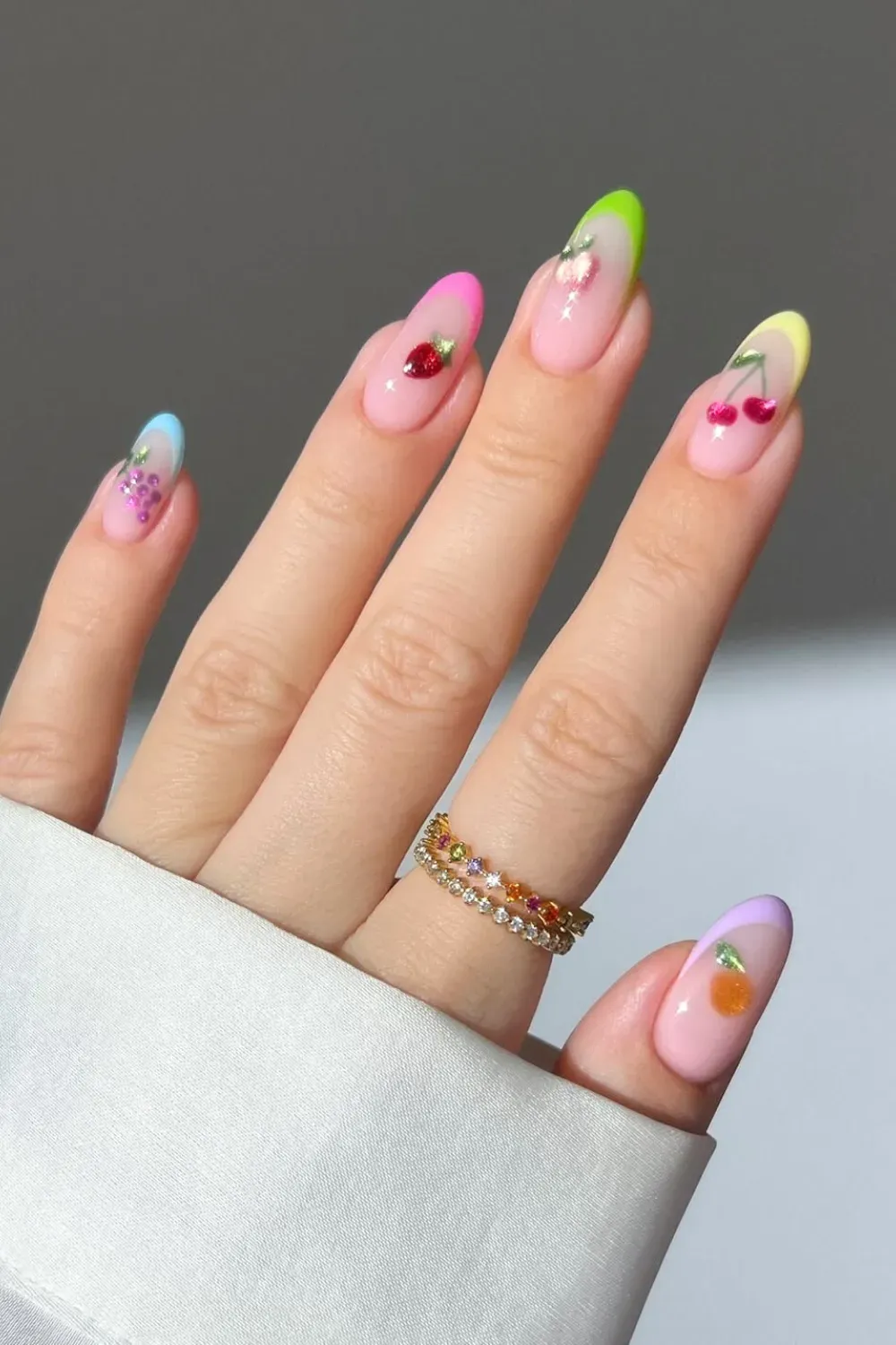 Colorful French tips with a fruity theme, featuring cherries and pineapples