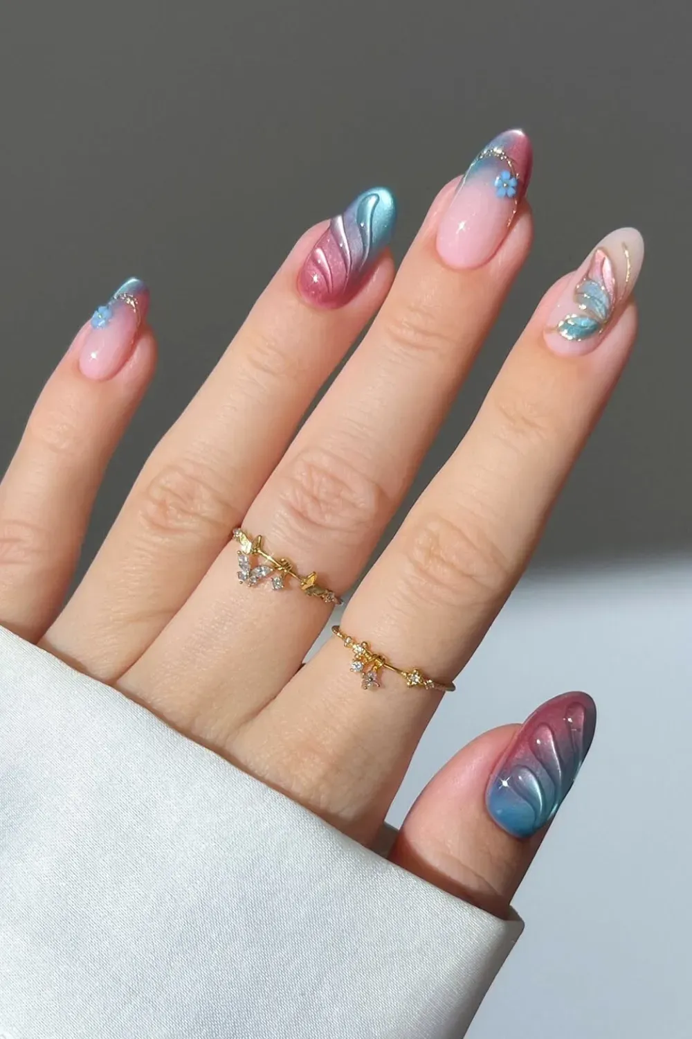 Colorful butterfly designs on nails with pastel gradients
