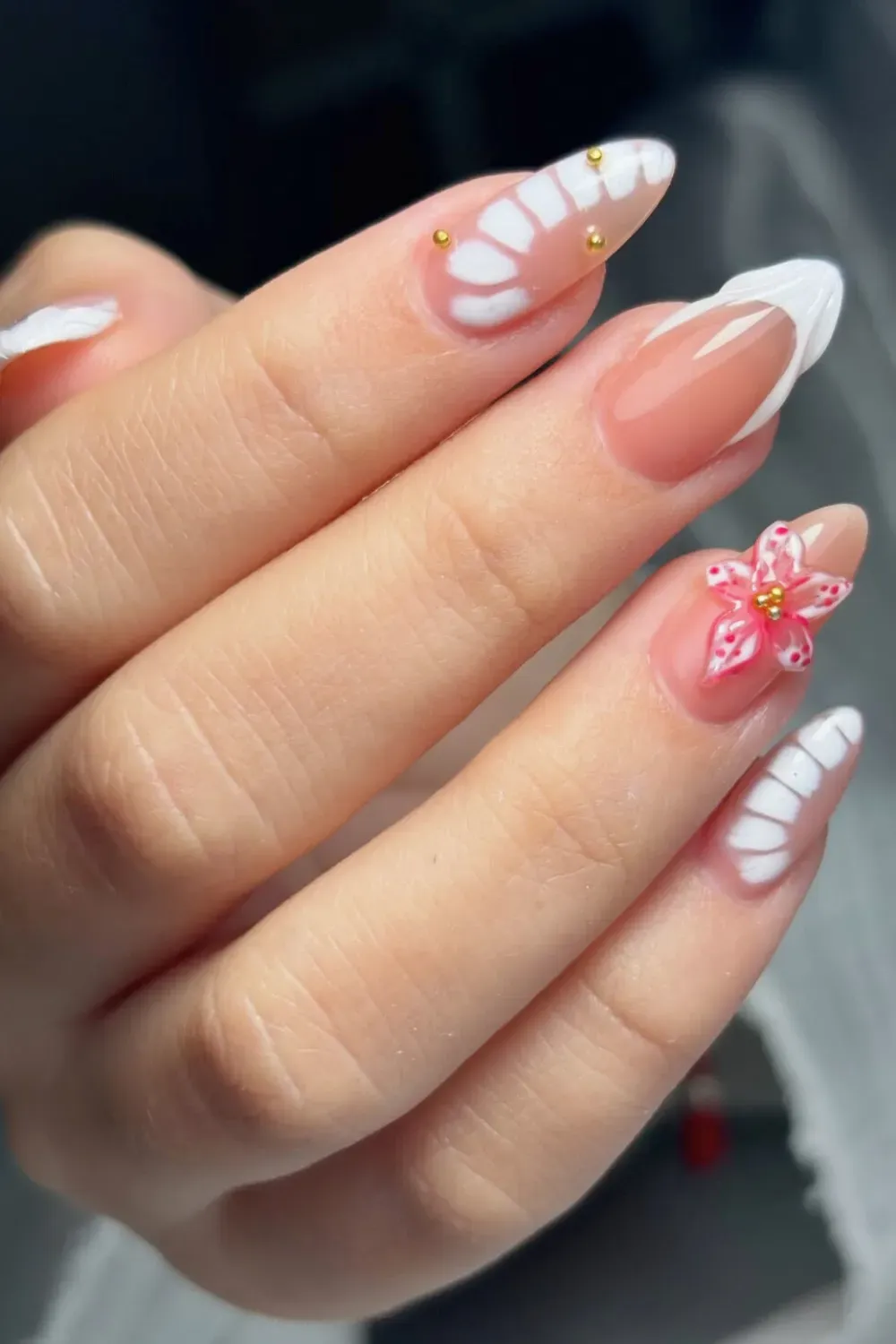 Cherry Blossom French Tips with Gold Accents Alt Text: Elegant cherry blossom floral French tips with soft pink flowers and gold detailing