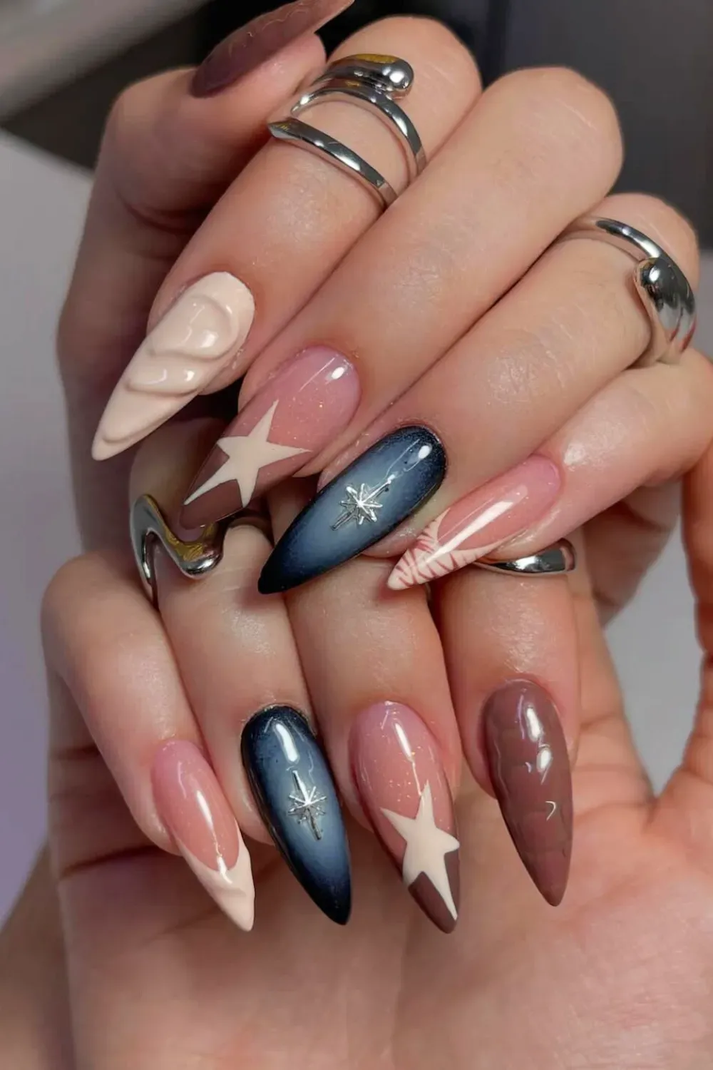 Elegant nude and white nails with a star accent for a refined look.