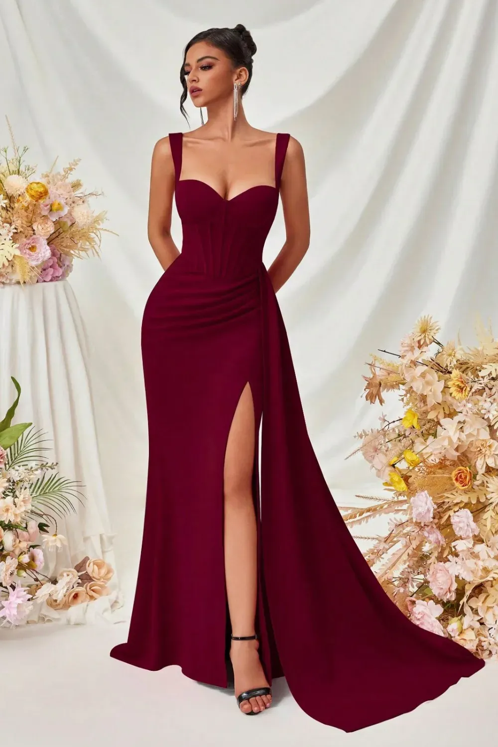 Stylish fitted red gown with corset bodice and daring slit.