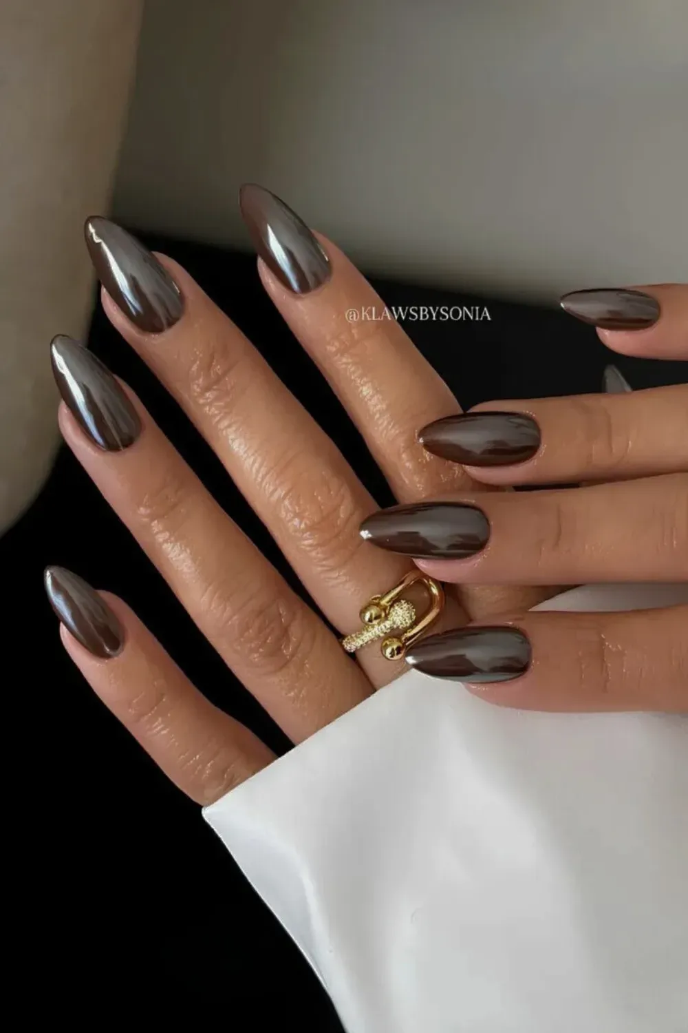 Brown nails with a reflective chrome finish