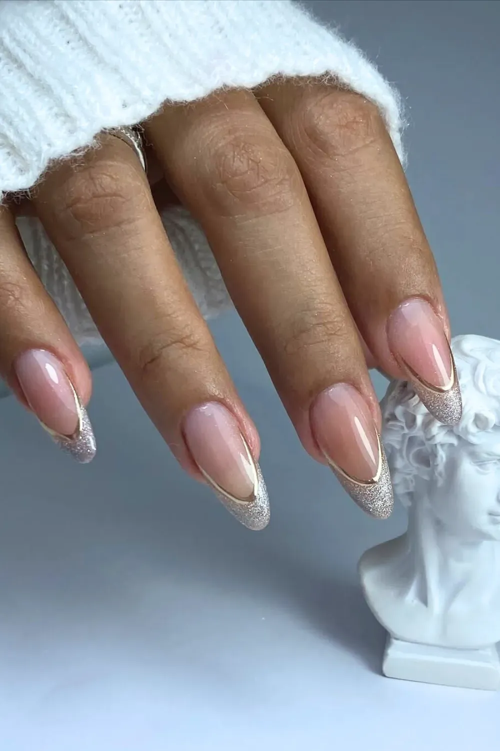 Elegant French manicure with a nude base and glittery silver tips