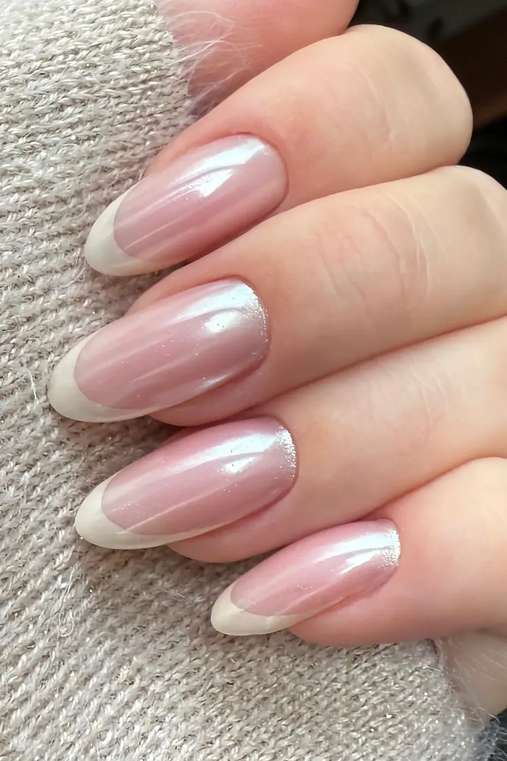 Classic French Tips with Shimmer – French tip nails with a soft pink base and white tips.