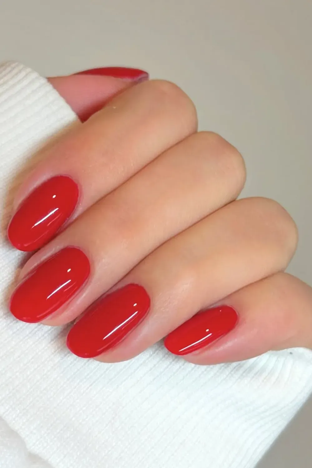 Bold and vibrant red nails with a shiny finish, perfect for making a timeless fashion statement
