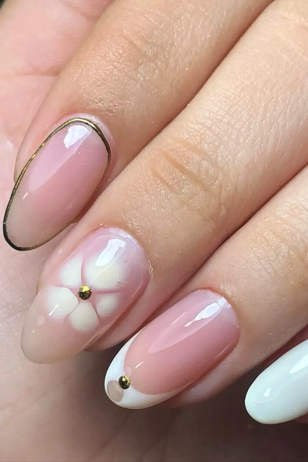 White French Tip Nails with a Gold Flower - Elegant French tip nails with a white flower design and gold accents for a sophisticated look