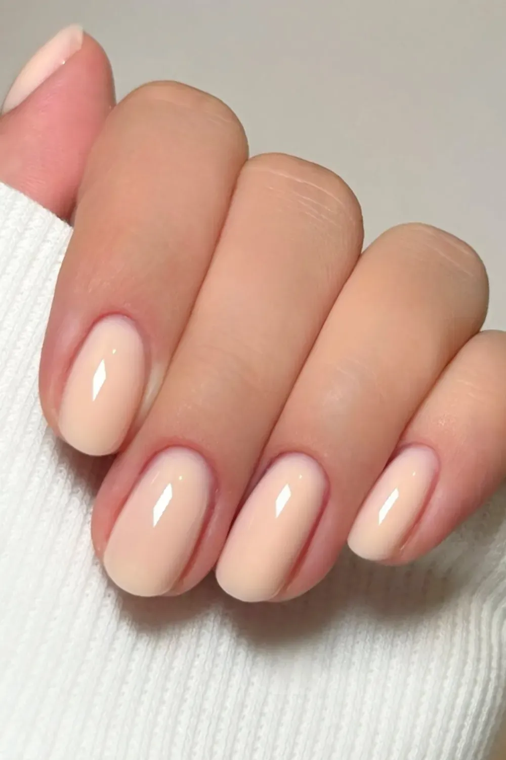 Timeless nude nails with a glossy finish, reflecting the clean girl aesthetic for an understated yet polished style