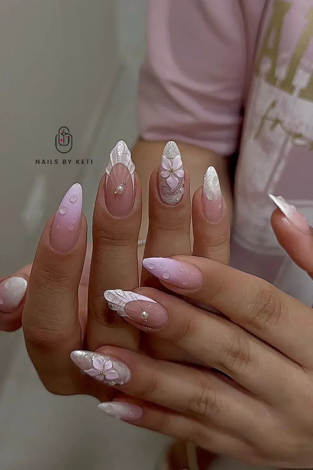 Elegant bridal nails with pink base and delicate 3D flower embellishments