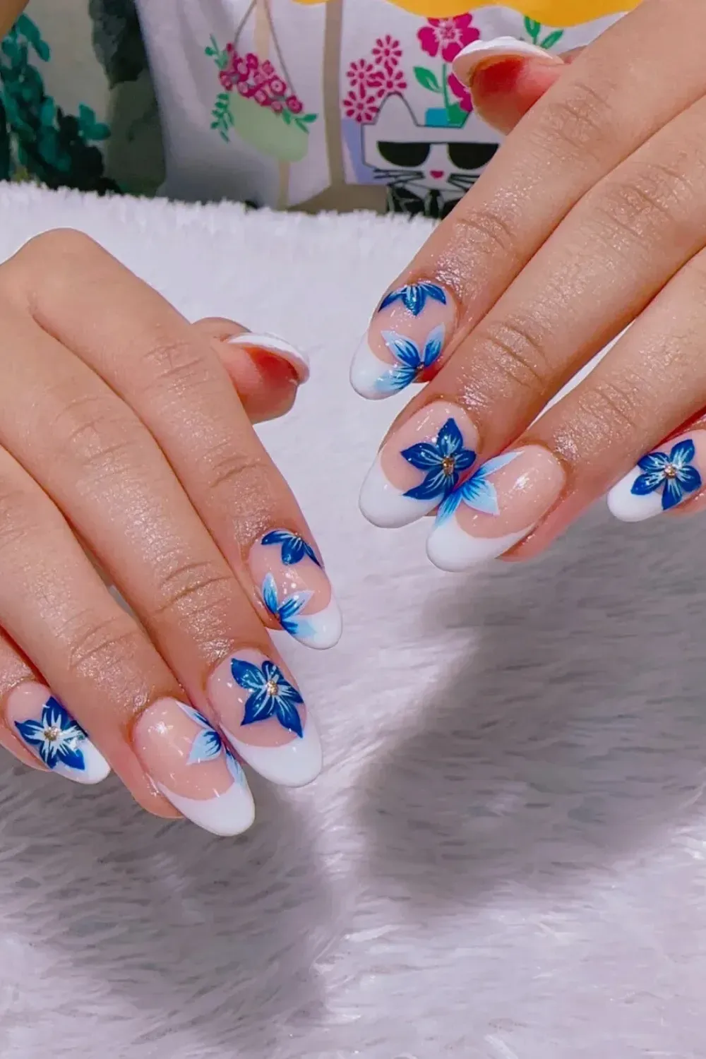 French Tips with Floral Accents - Classic French tips with delicate blue floral accents