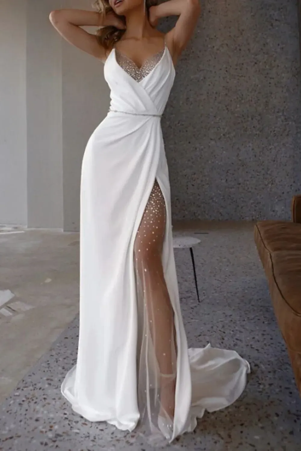 Elegant white gown with a beaded sheer skirt, perfect for glamorous events