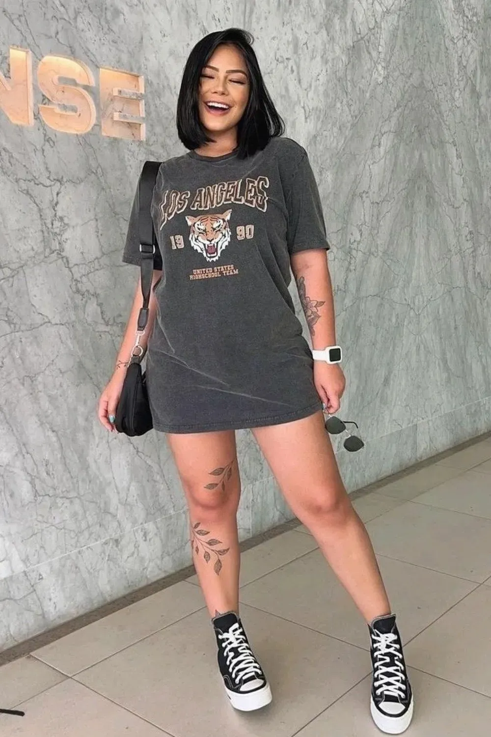 Graphic Tee Dress with Sneakers - A woman smiling and wearing a graphic tee dress with sneakers