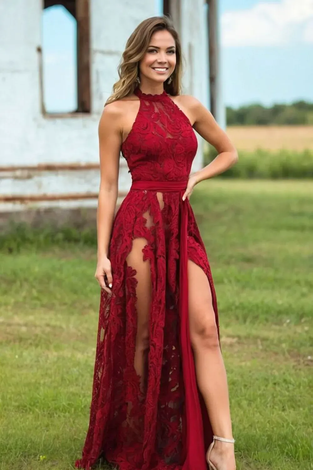 Red lace halter gown with intricate floral details and sheer panels.