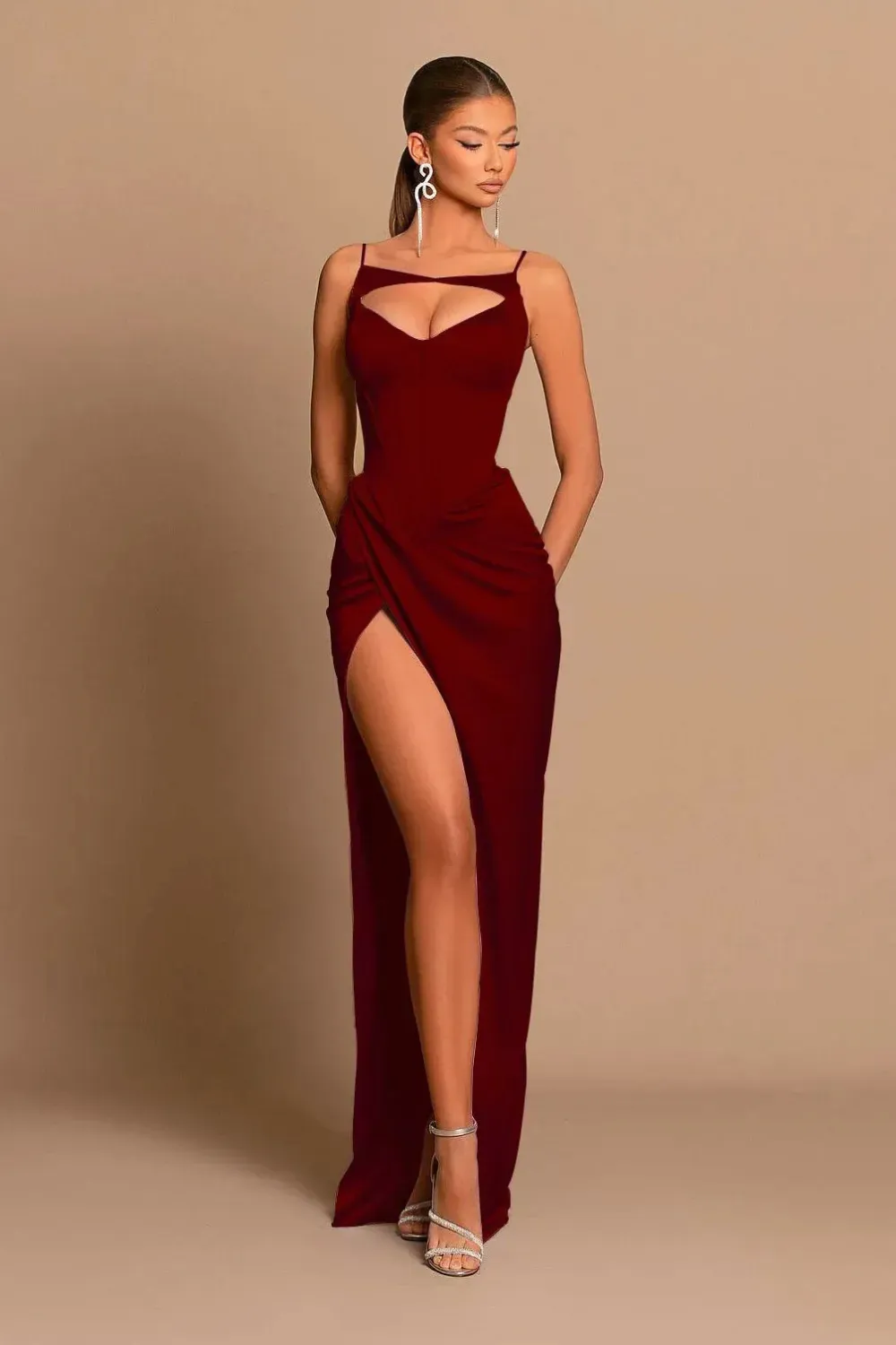 Elegant fitted red gown with sleek straps and subtle cutout detail.