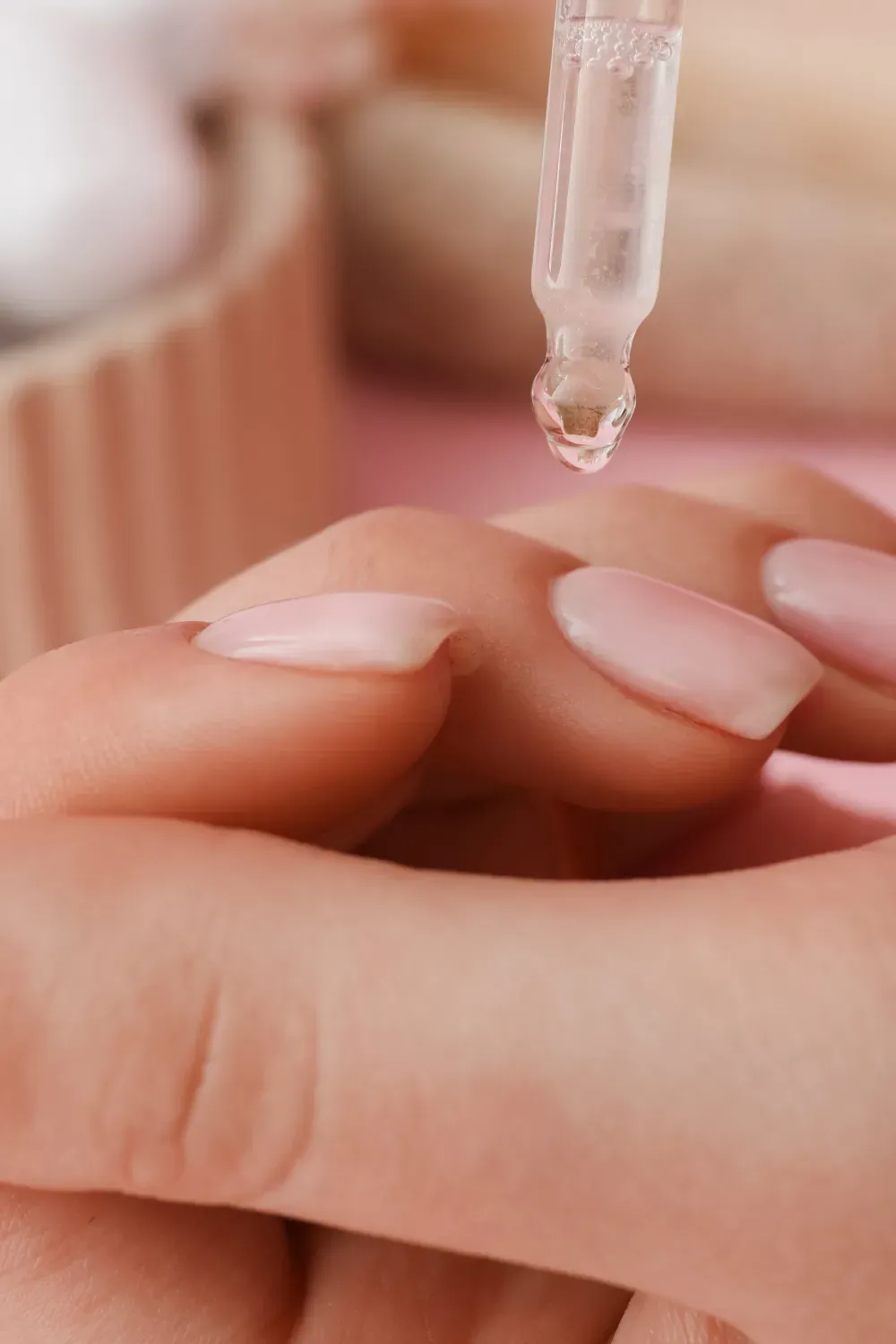 Natural nail care at home - Woman applying cuticle oil for natural nail health