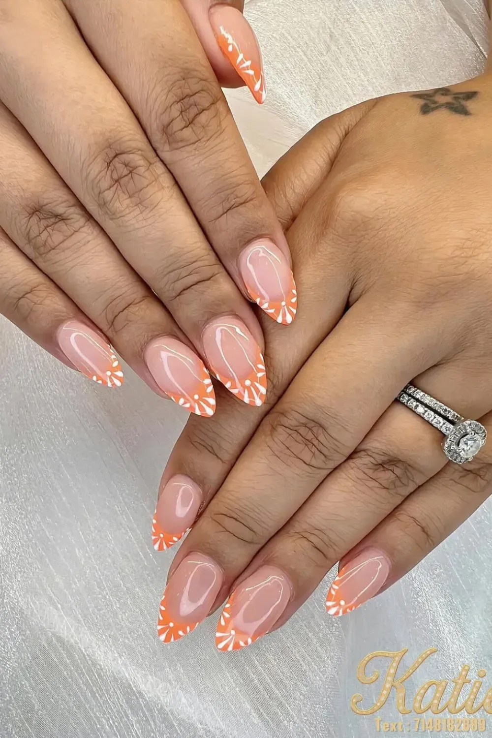 Vibrant Orange Floral French Tips - Bold orange French tips adorned with delicate floral accents for a vibrant and summery design