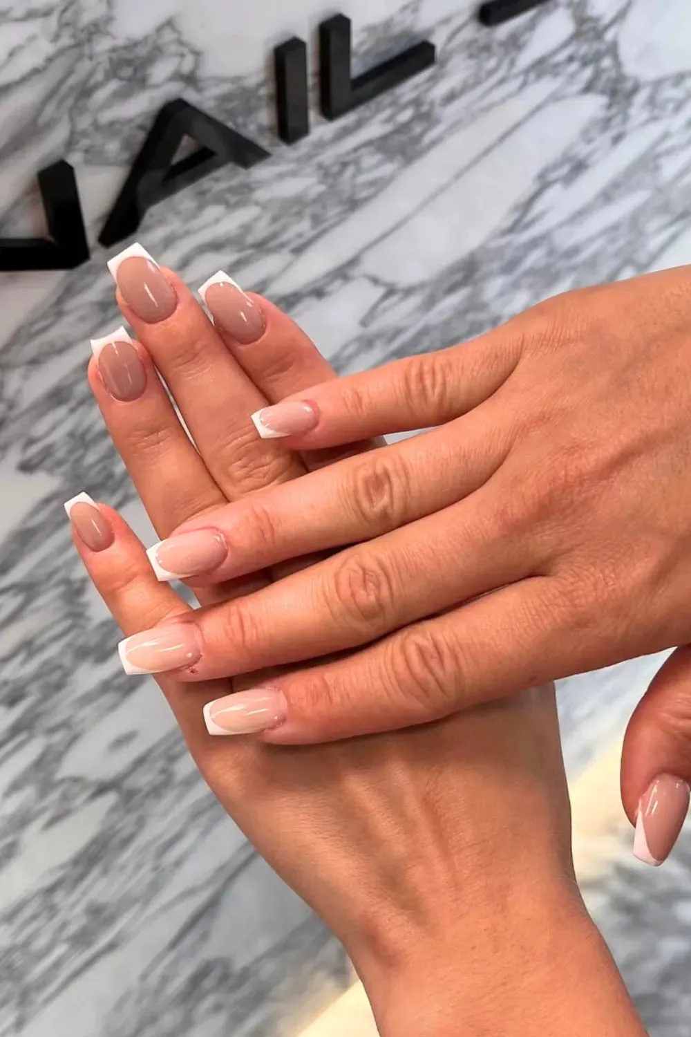 Beige French tips with a subtle nude gradient for a minimalist and chic look