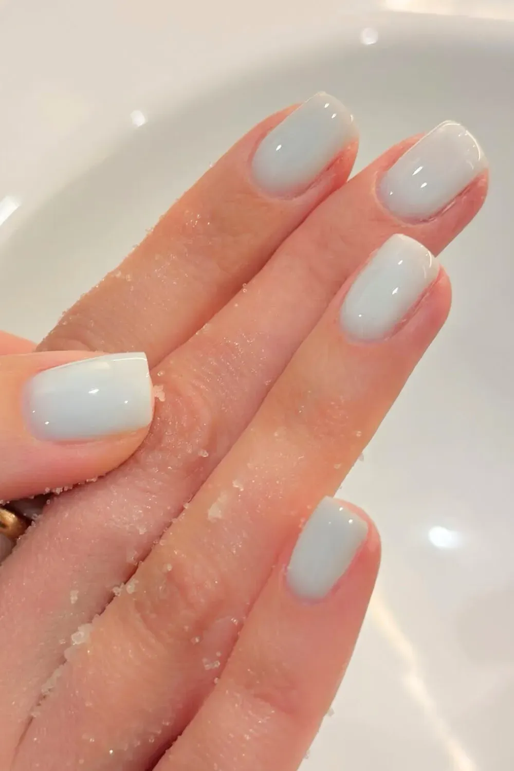 A stylish French manicure featuring a classic nude base with bold blue tips, offering a modern twist on the traditional design