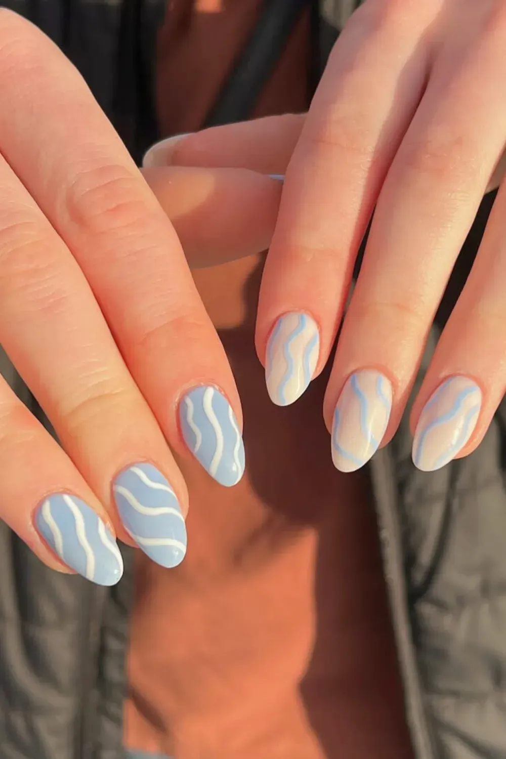 Dreamy ocean-inspired blue nails with wave patterns