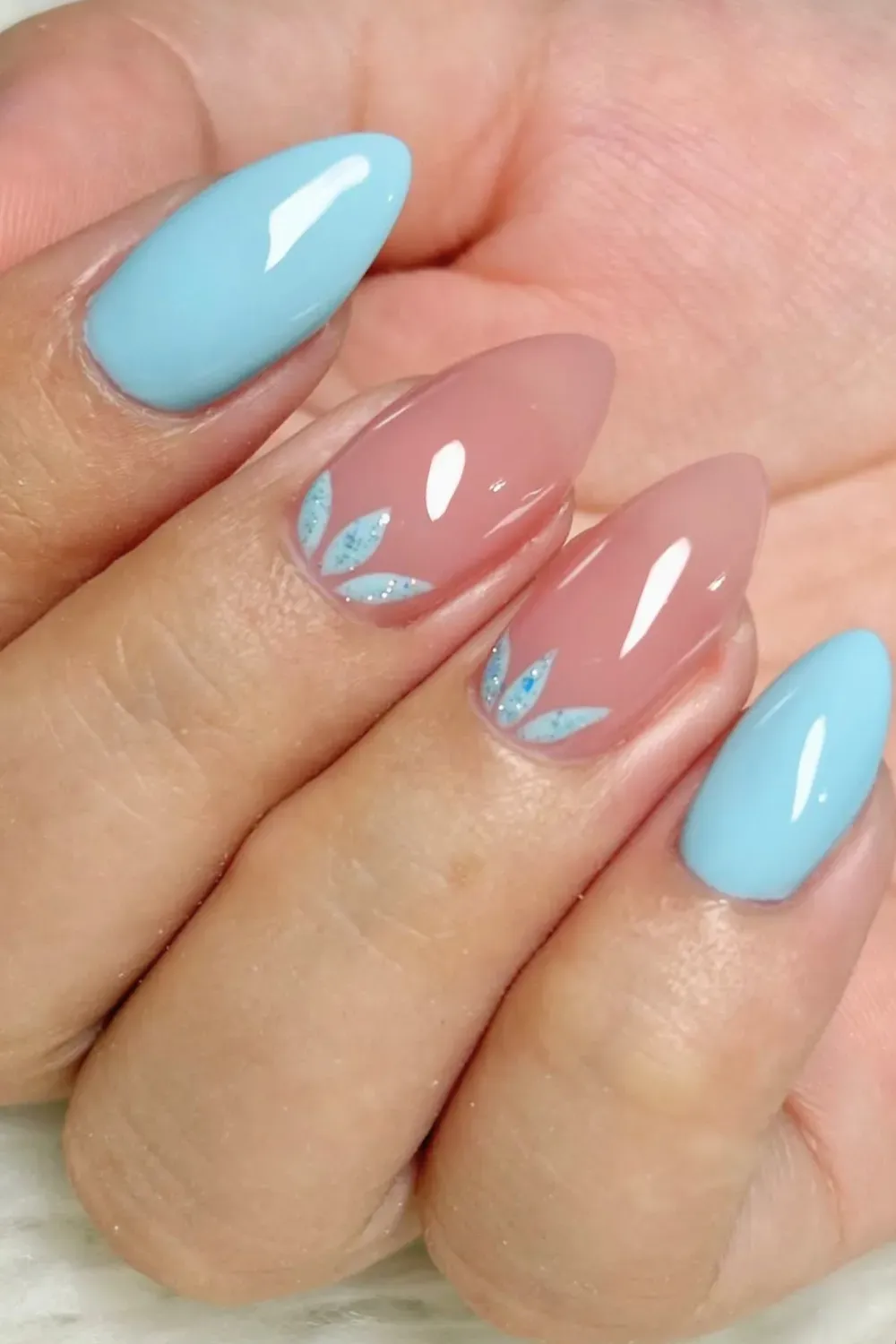 Artistic pastel blue and nude nails with a delicate design, perfect for a refreshing summer look