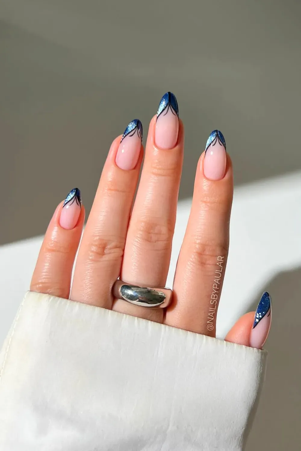 French tips with blue tips and silver geometric designs for a creative and chic back-to-school nail style