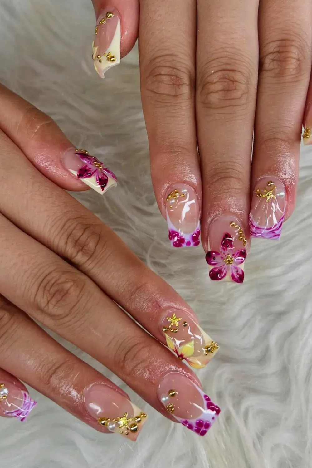 Peach French Tips with Orchid Details Alt Text: Peach-colored French tips with delicate orchid floral accents for an elegant and soft design