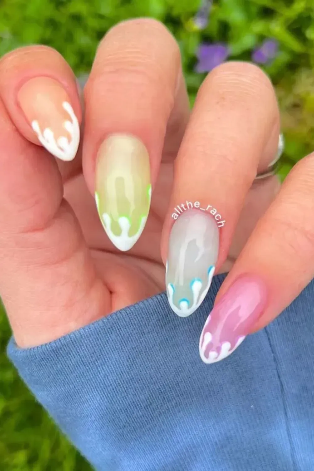 Multicolor Flame Drip Nails - Almond-shaped nails with pink, green, blue, and white drip tip art on translucent bases