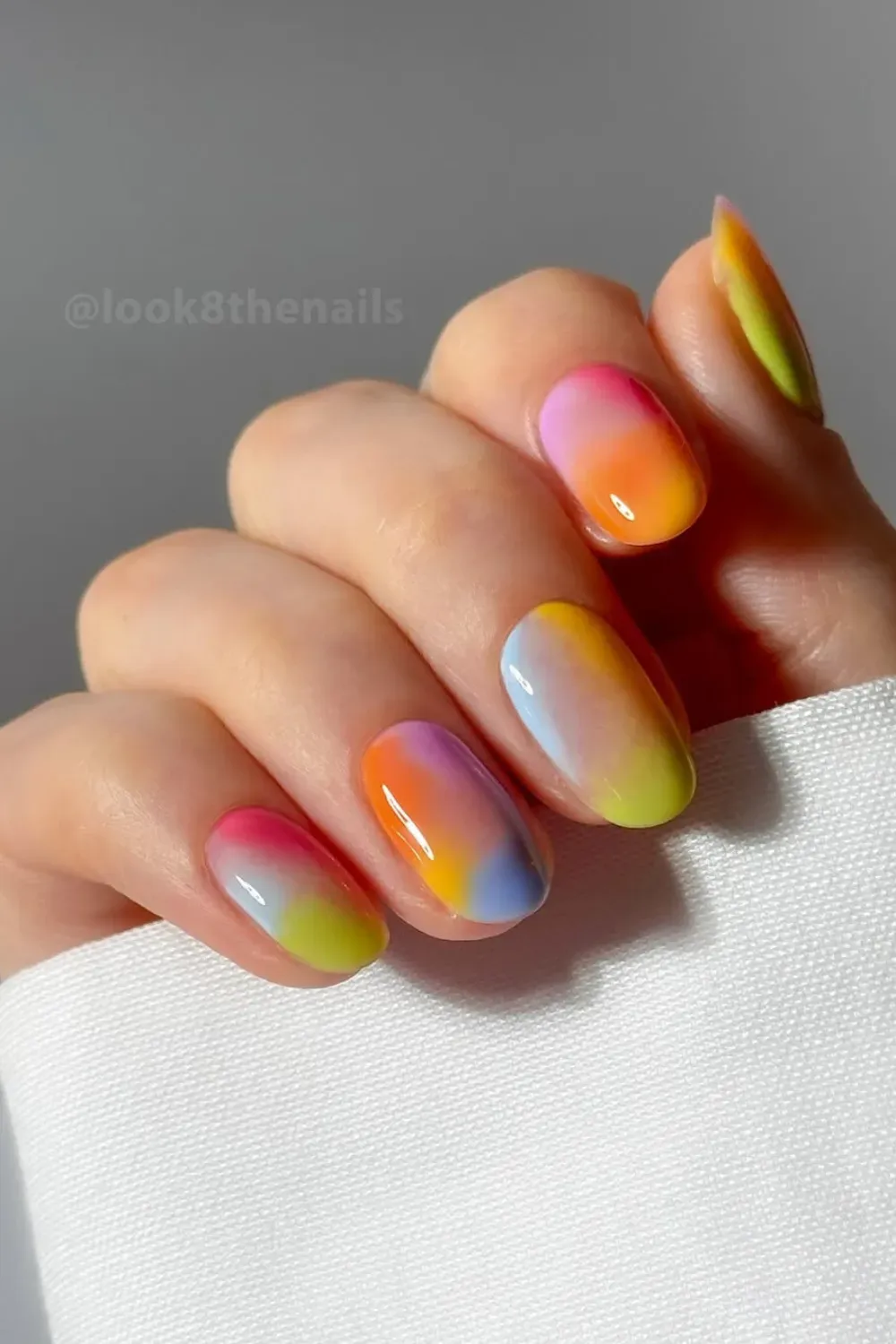 Vibrant rainbow gradient nails with smooth transitions between colors