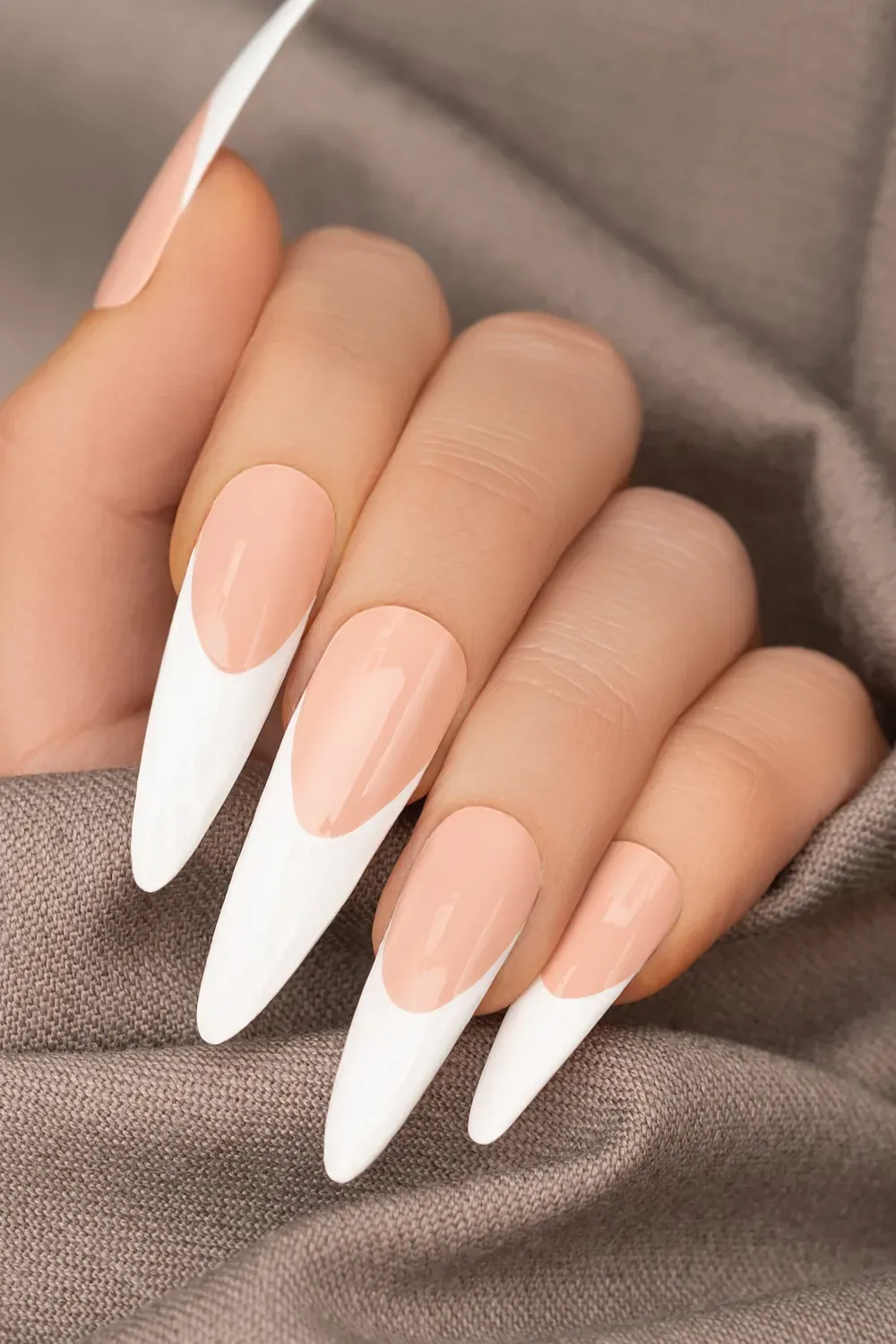 Pointed French Tips – Bold pointed French tip design with a nude base and white tips.