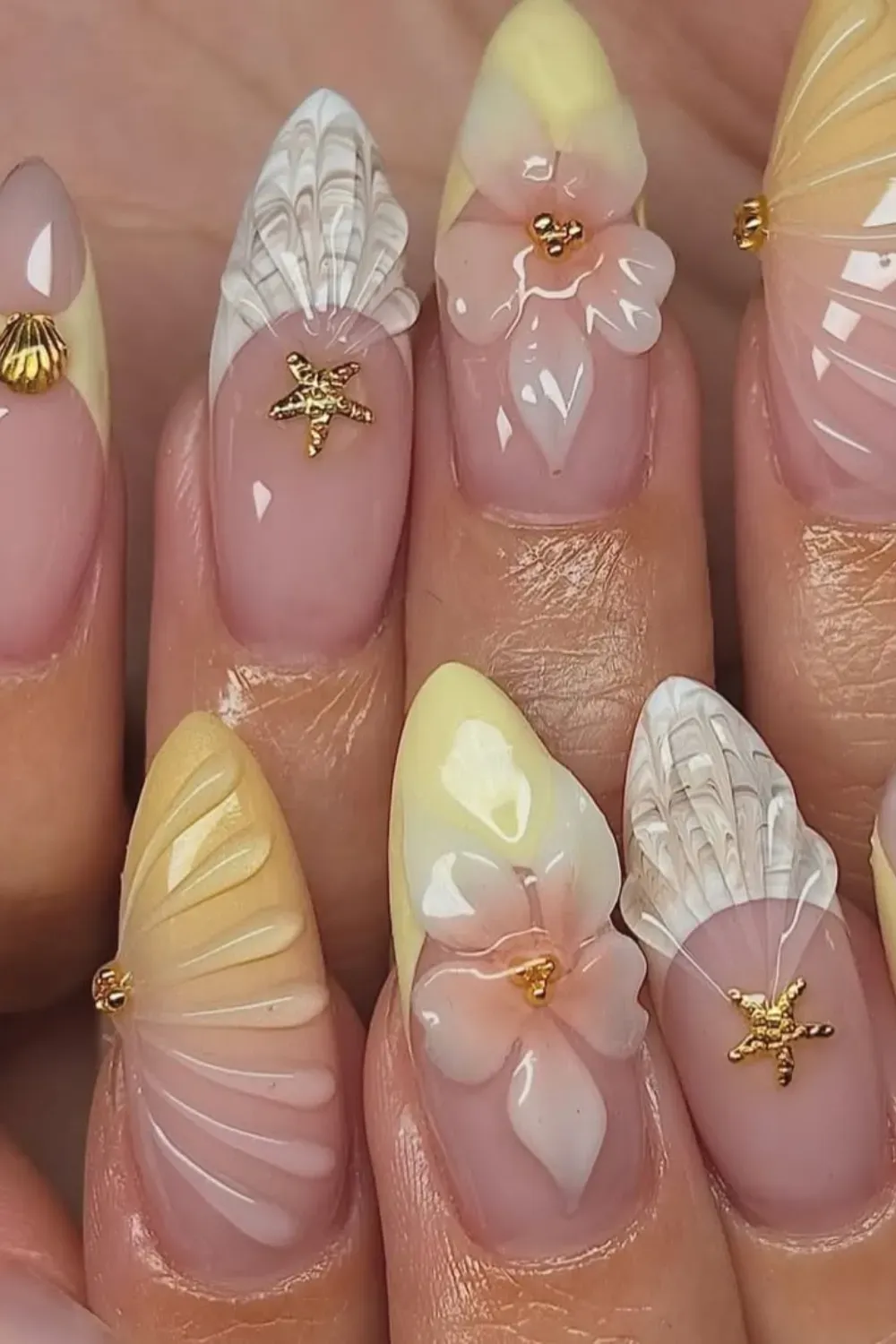 Sophisticated starfish nails adorned with gold and pearl accents for a luxurious beach look