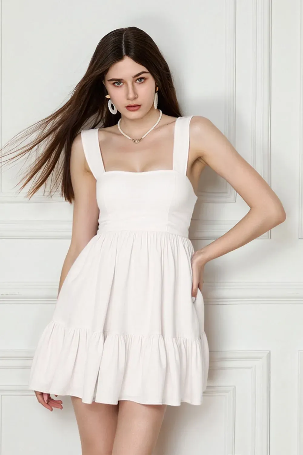 Sweetheart White Mini Dress – Front & Back Bow Detail - Woman wearing white mini dress with sweetheart neckline and back bow detail