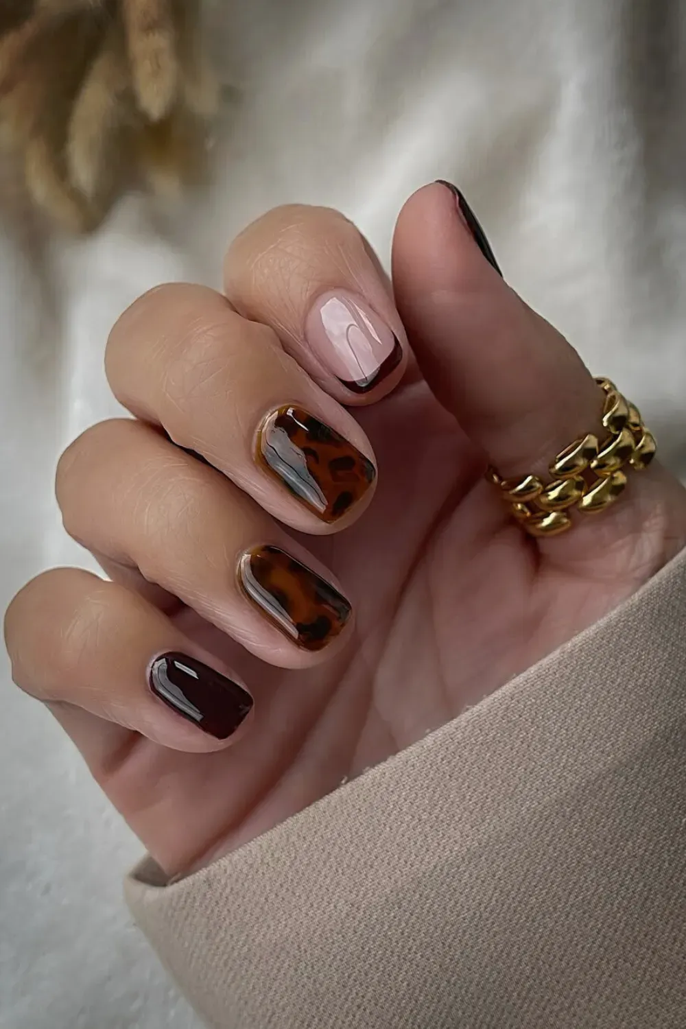  Elegant tortoise shell nails with rich brown and amber tones for a chic look