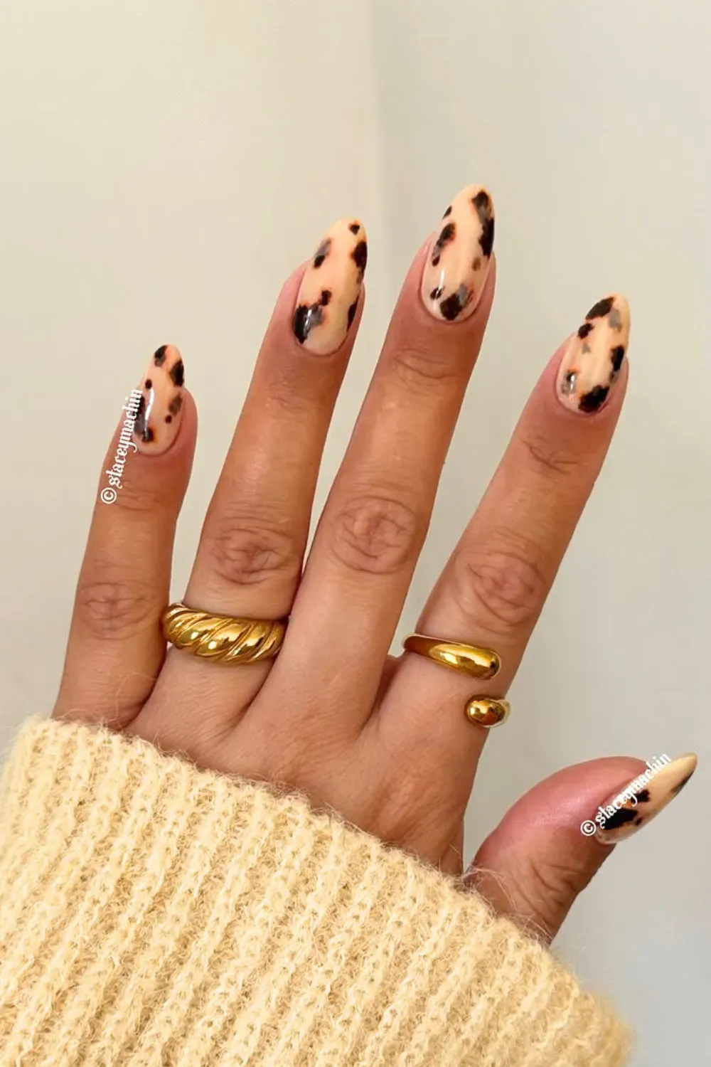 A hand adorned with tortoiseshell nails, ideal for transitioning into autumn.