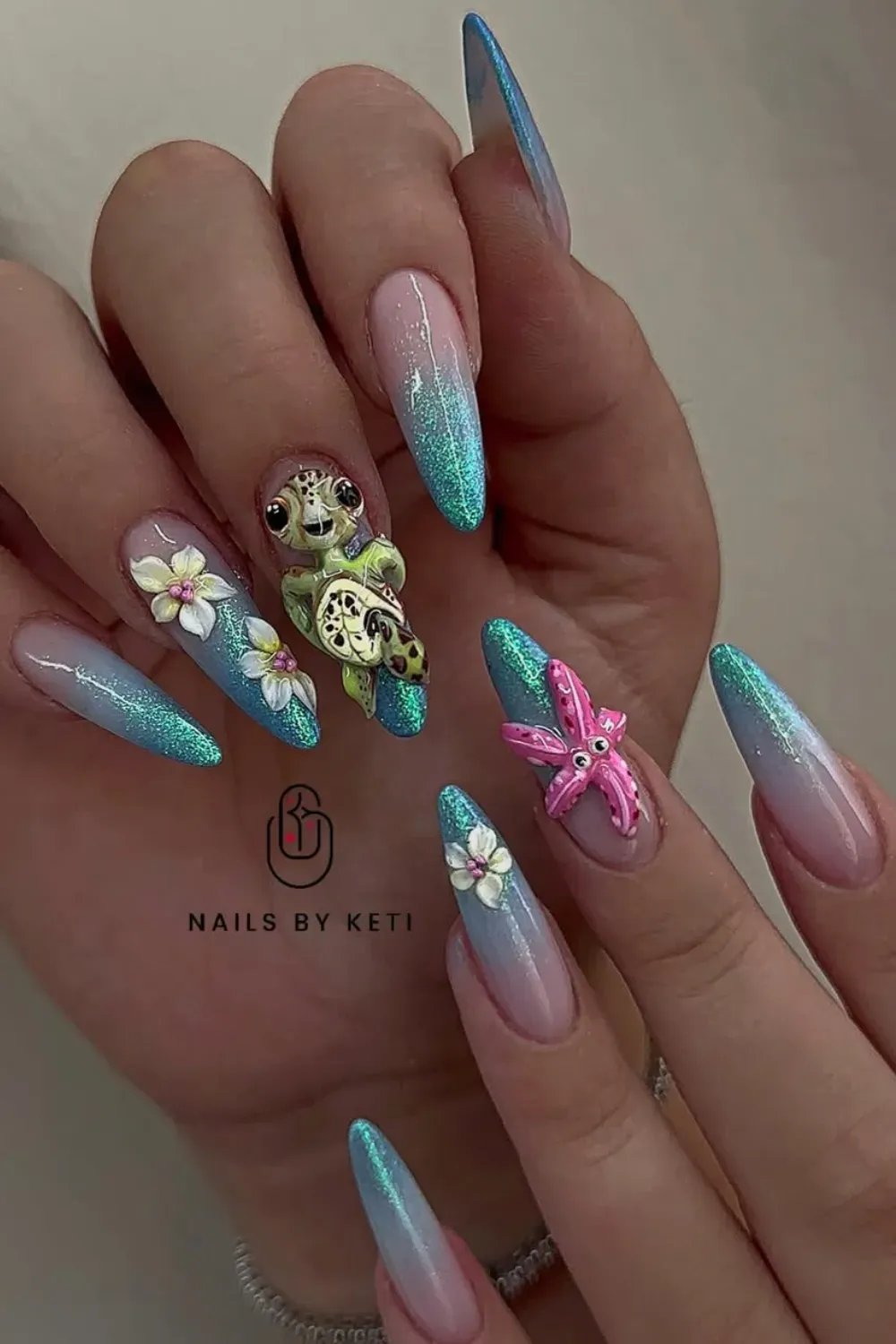 Ombre nails with a 3D turtle and seashell design, perfect for beach lovers