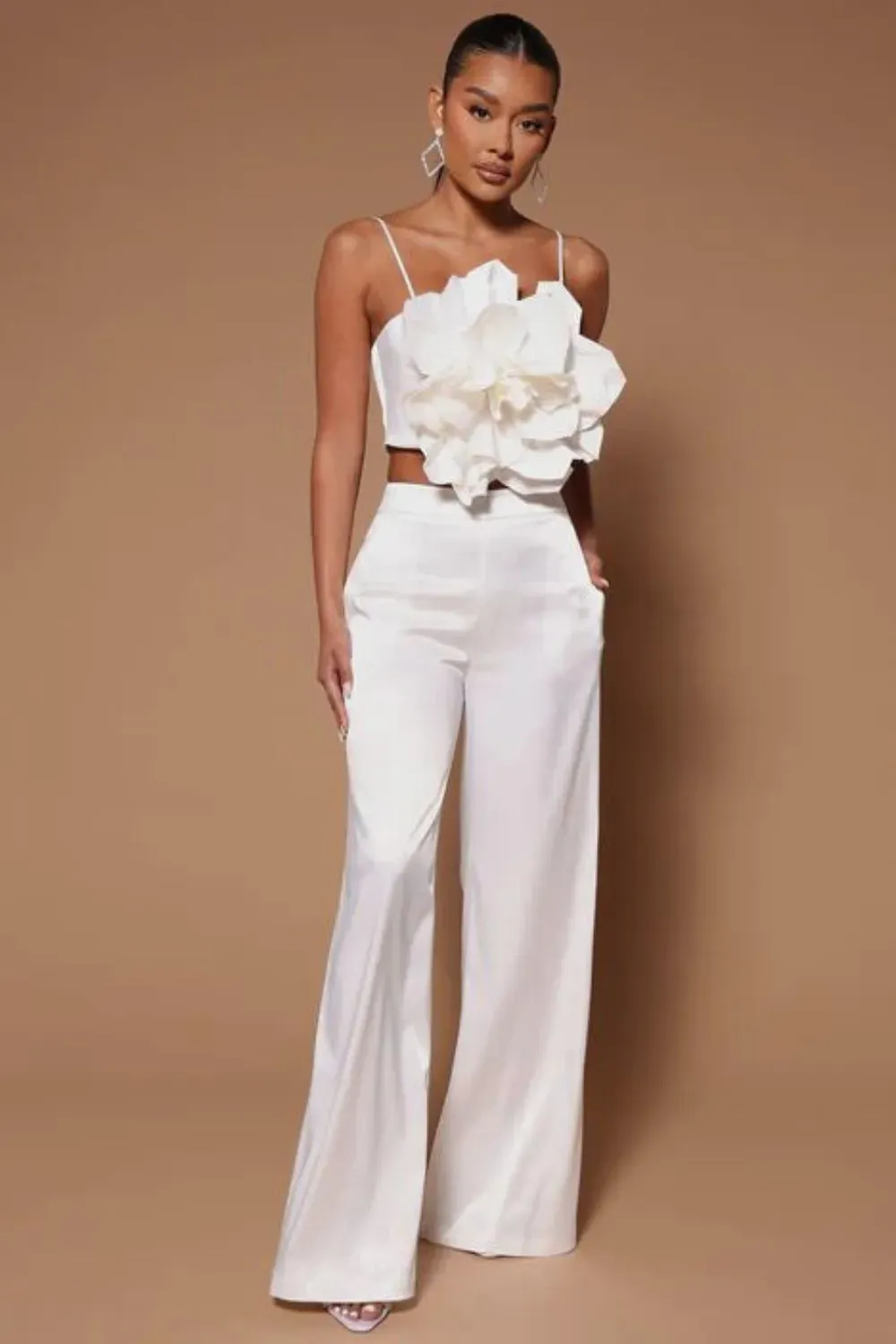 Modern white floral top paired with wide-leg pants, ideal for trendy dinner or brunch events