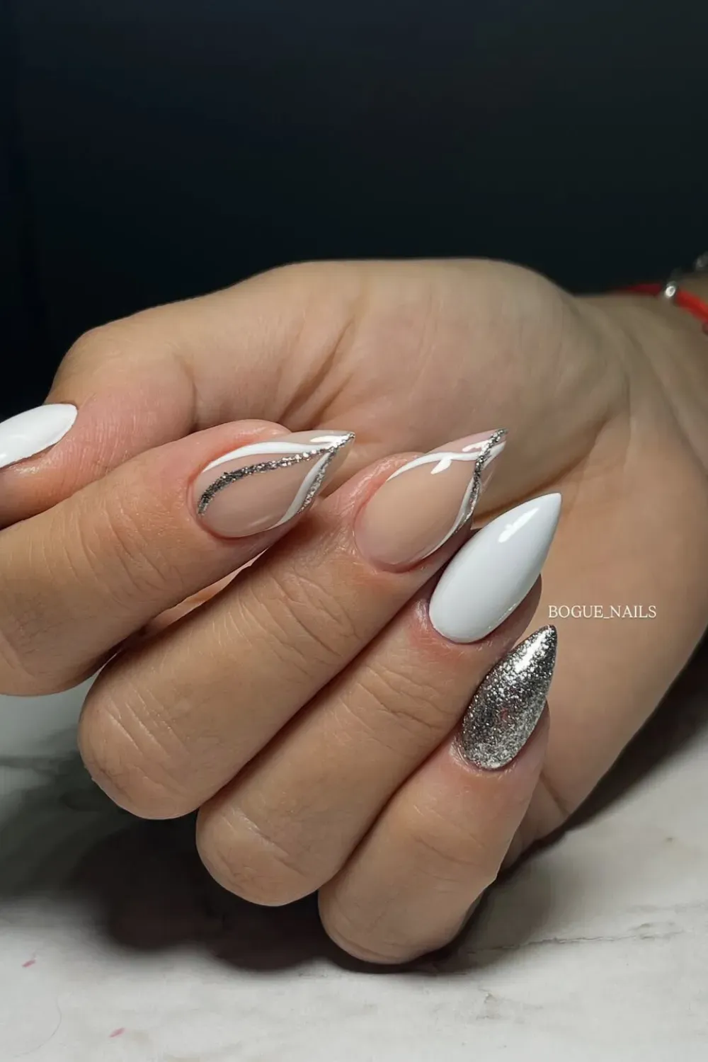 Modern white and silver geometric nail art with sleek metallic accents