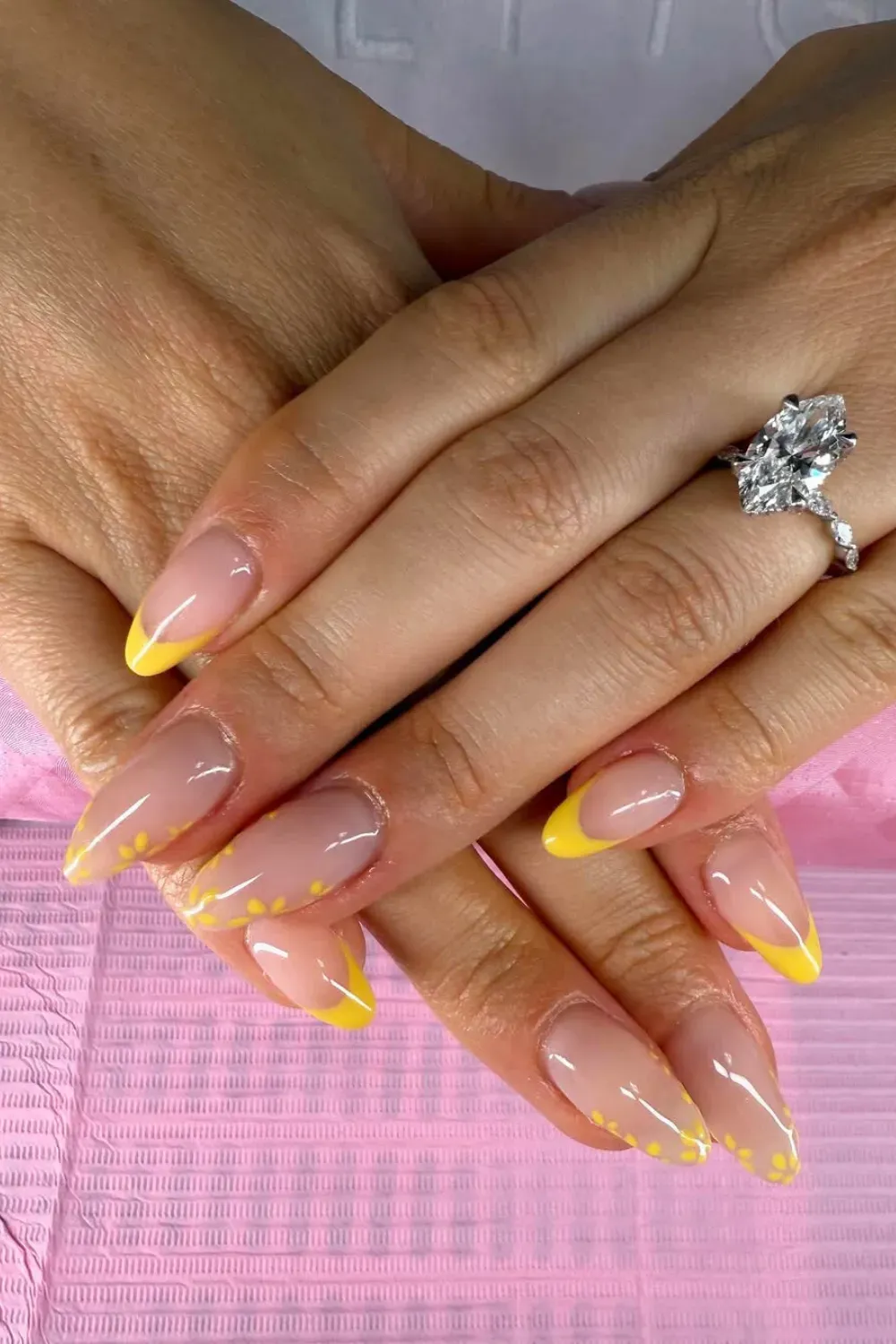 Yellow French Tips with Subtle Floral Dots - Bright yellow French tip nails with subtle floral dots for a cheerful and spring-inspired design.