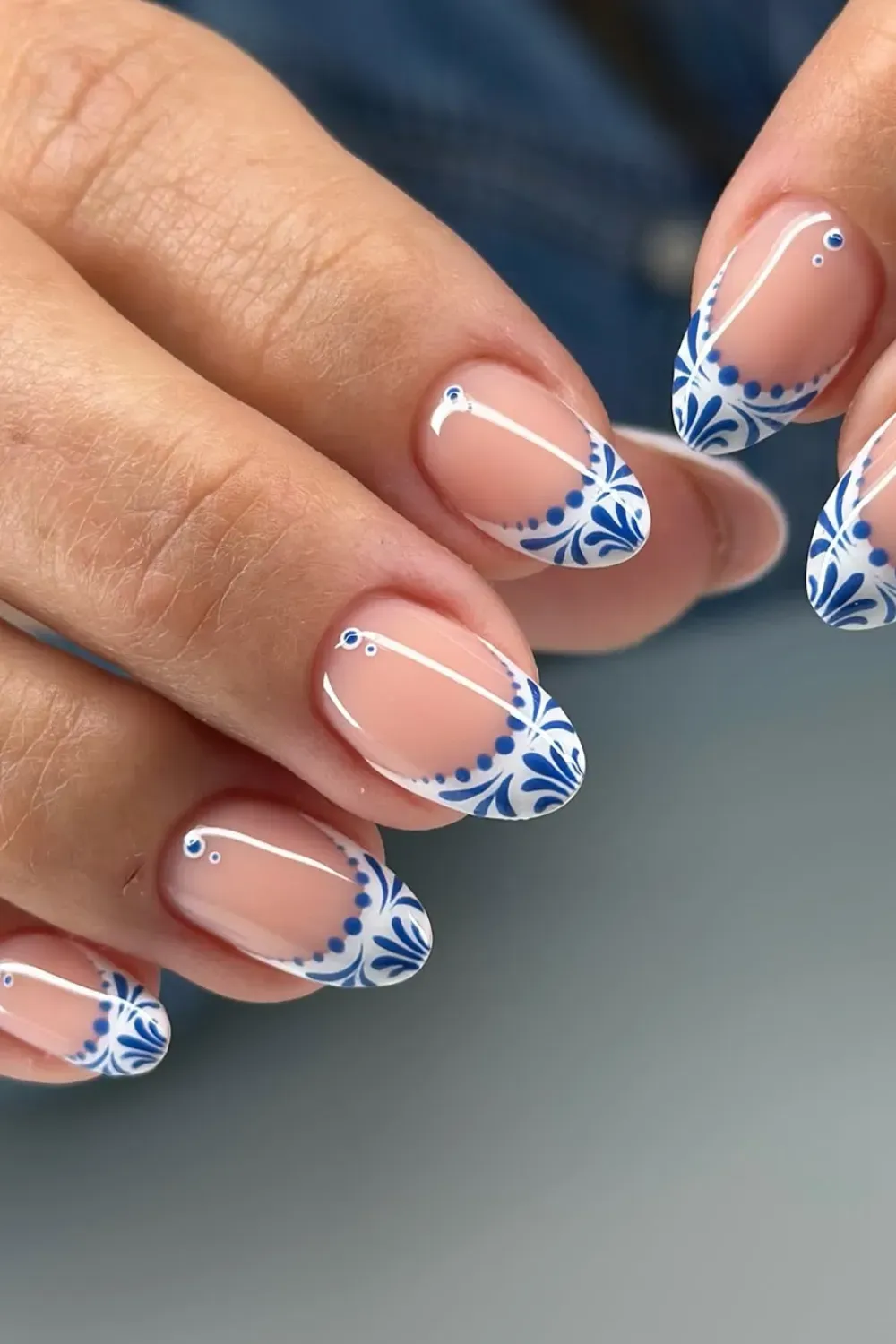 Artistic Blue and White Floral French Tips - Blue and white floral designs on French tip nails with tiny rhinestones