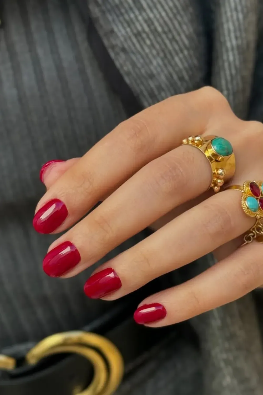 Vibrant red nails with a glossy finish, making a bold statement