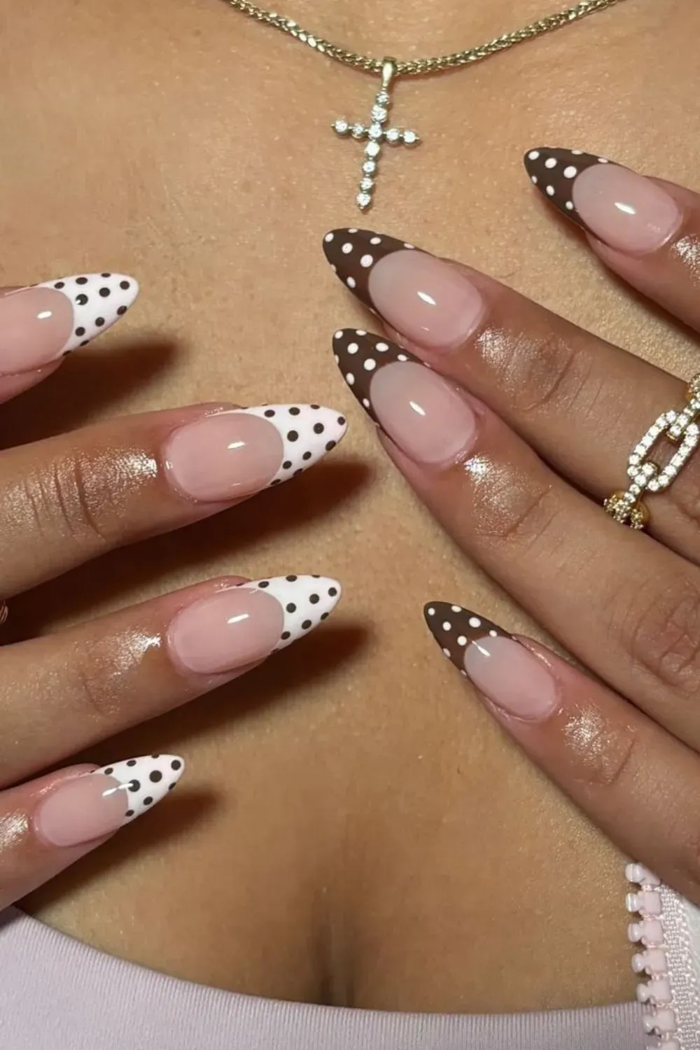 Stylish brown and white polka dot nails with playful patterns, perfect for a chic fall look