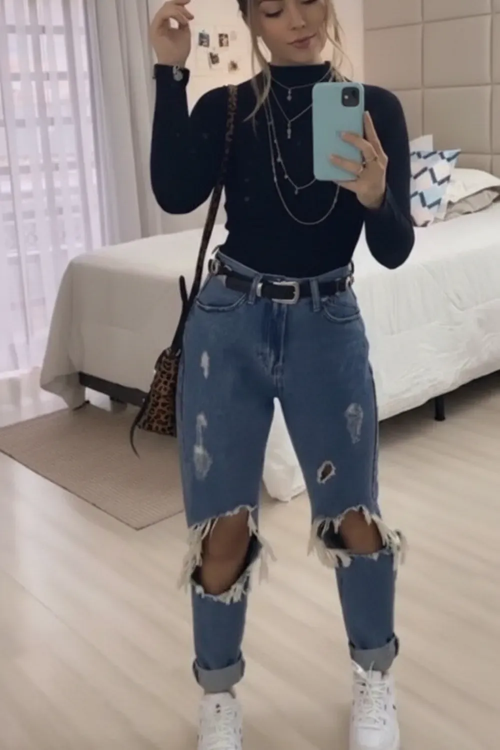 Casual Chic with Ripped Denim - A stylish outfit featuring ripped denim jeans and a black turtleneck, ideal for casual outings.