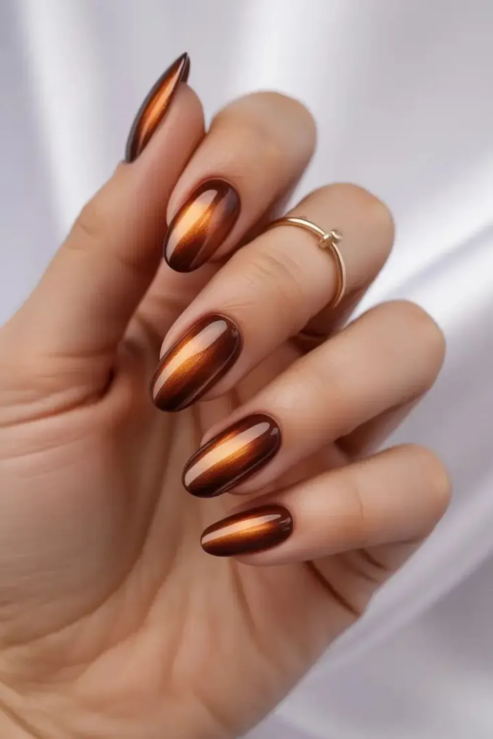  Brown gradient nails with a captivating cat-eye effect, showcasing a magnetic shimmer for a luxurious and stylish look