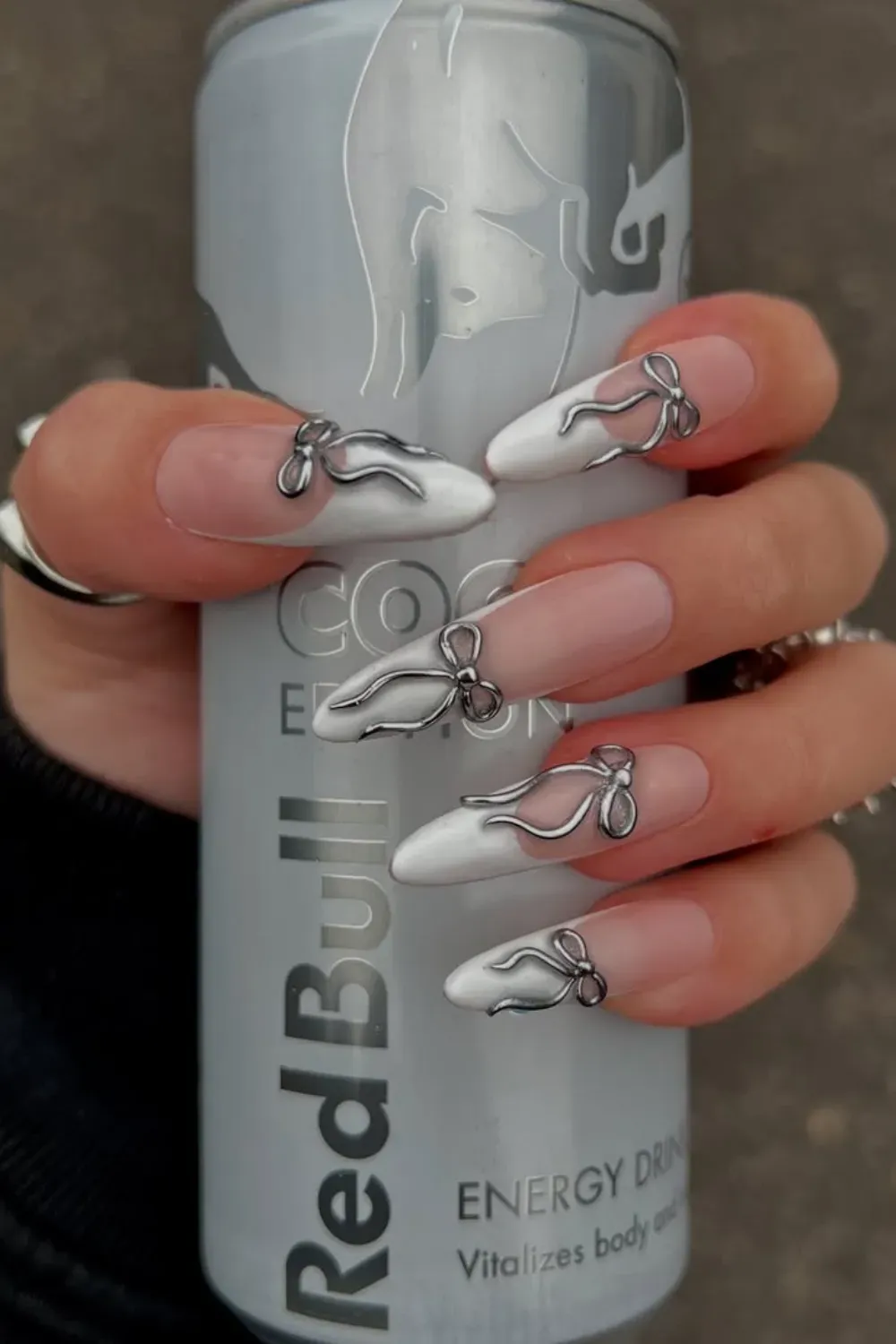 White and Silver Accent Halloween Nails- Elegant white nails with metallic silver accents for a modern Halloween design