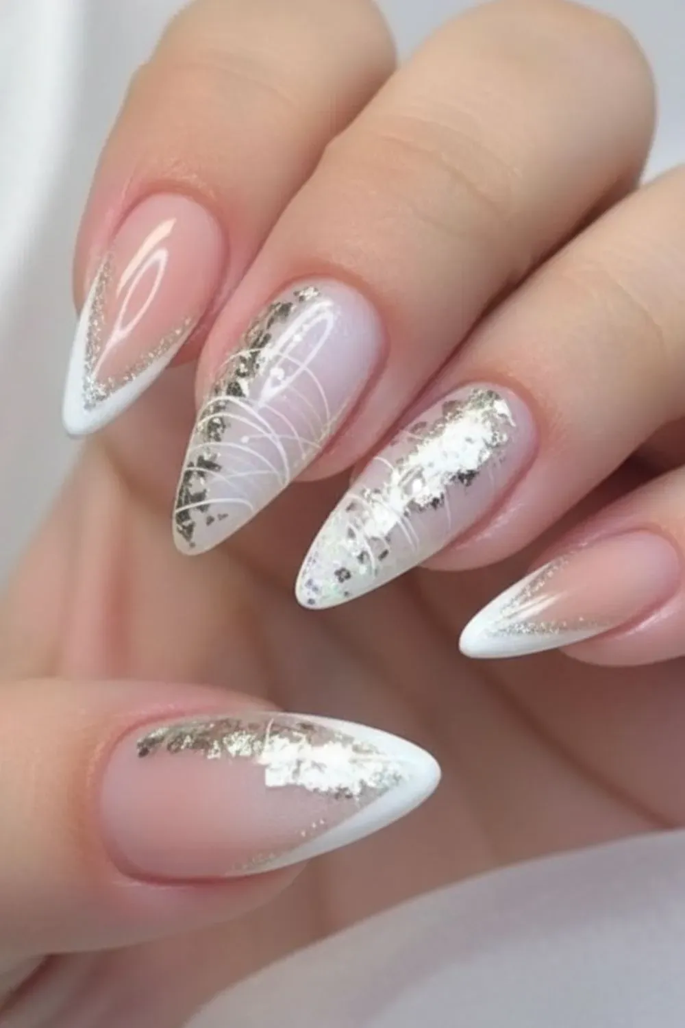 Chrome French tips with glitter accents for a chic finish.