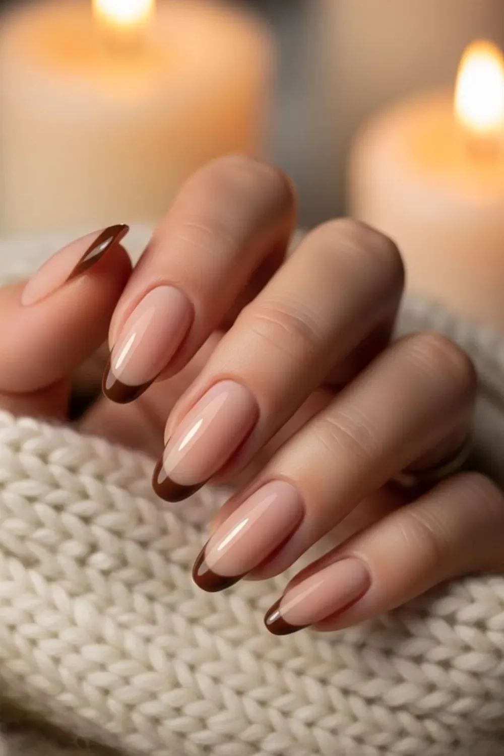 Elegant brown French tip nails with a nude base and glossy finish, creating a chic and cozy look