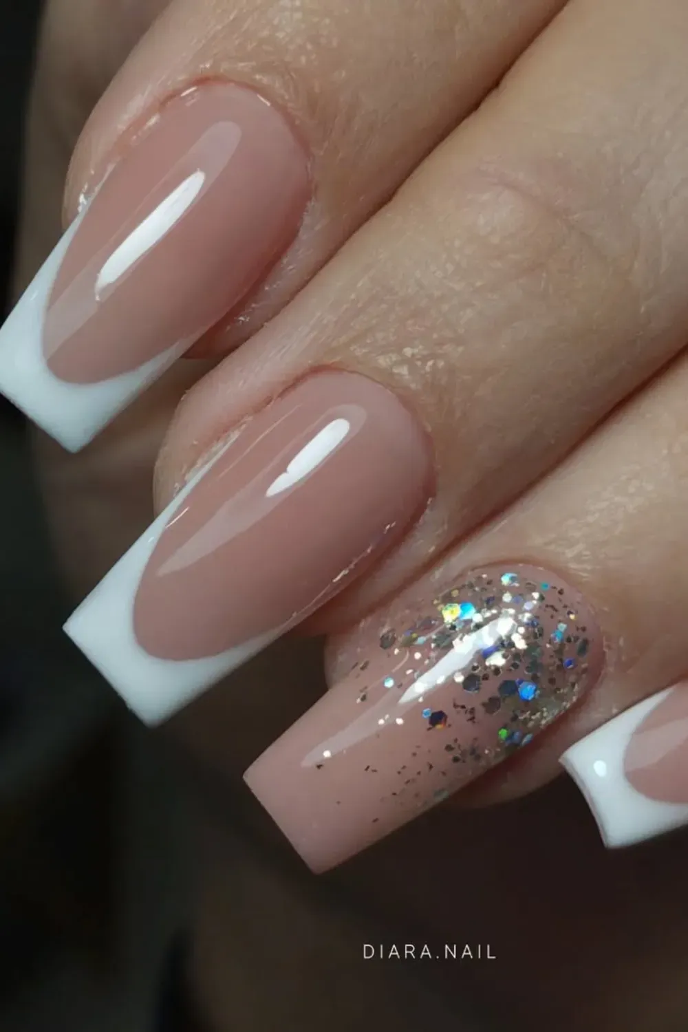 Glittering French Tips - Classic white French tips with a touch of glitter for a sparkling and glamorous design