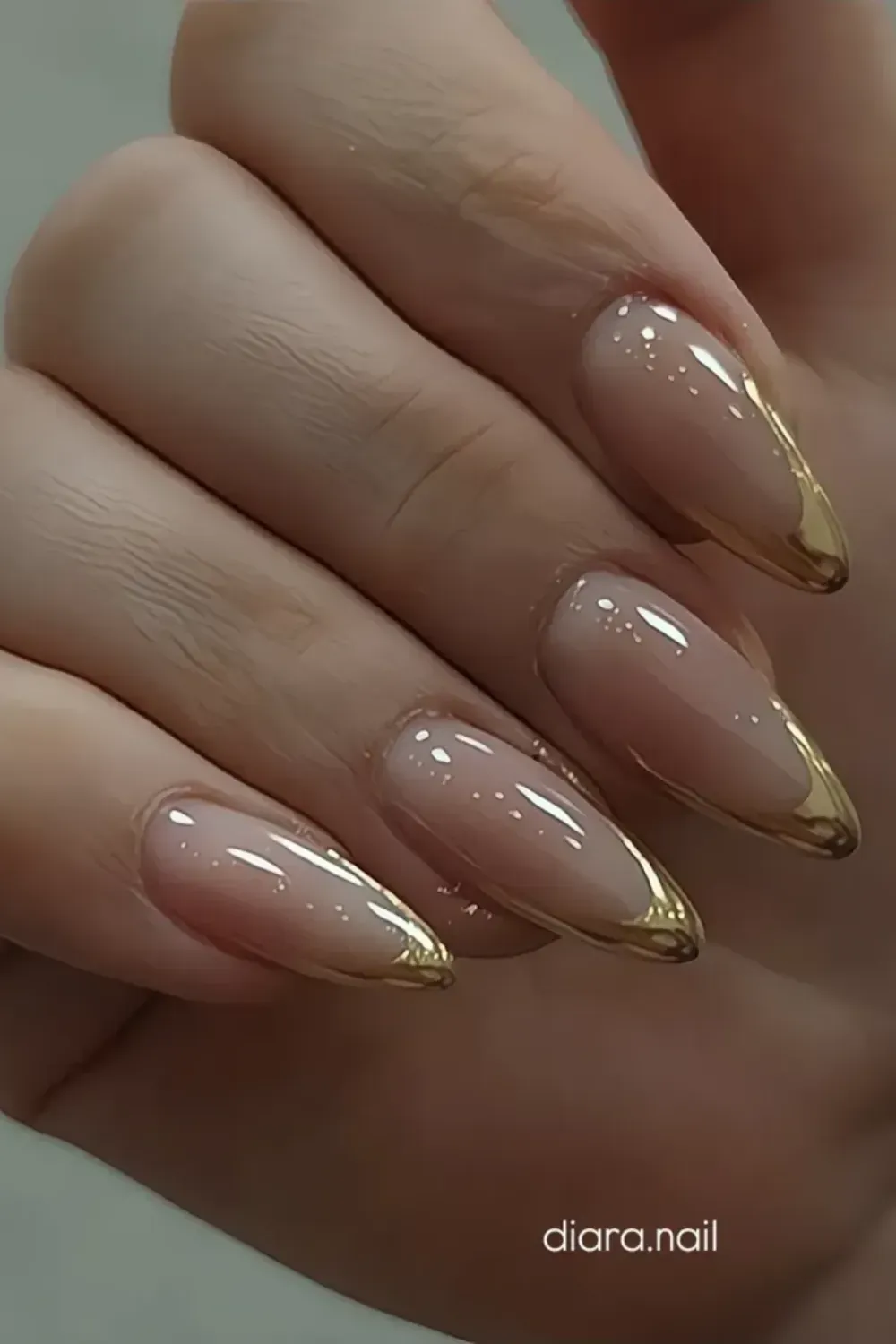 Gold French Tips - Elegant gold French tips on nude nails, offering a luxurious and sophisticated design.