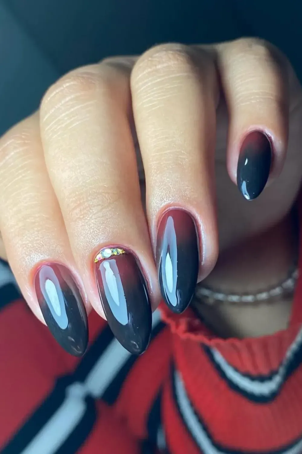 Dark Burgundy Halloween Nail Design with Gem Accent - Dark glossy nails with a burgundy ombre effect and a gem accent on the ring finger