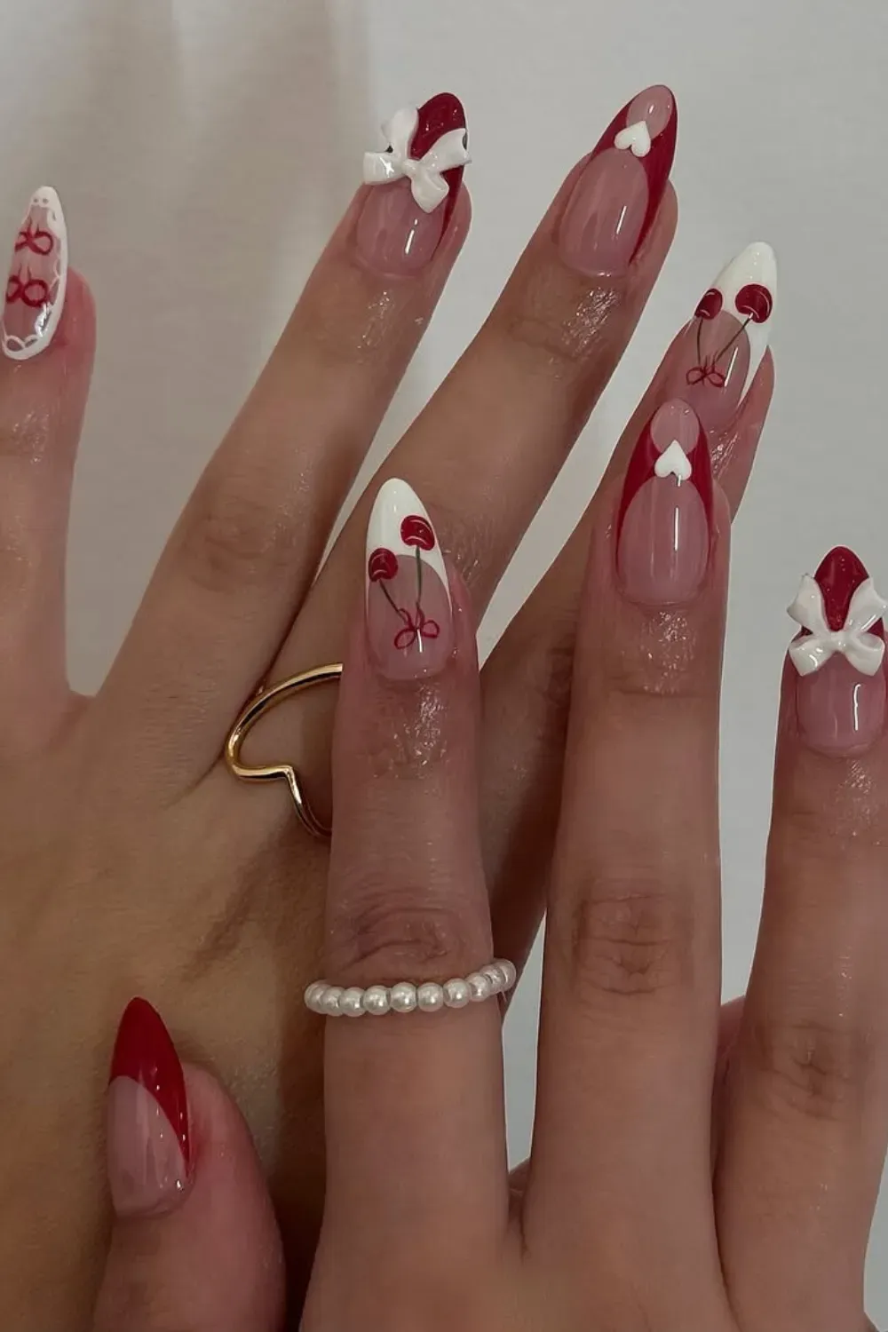 Lover Girl Mixed & Matched Autumn Nails - Mixed red, white, and nude nails featuring hearts and bows for a sweet and stylish autumn design.