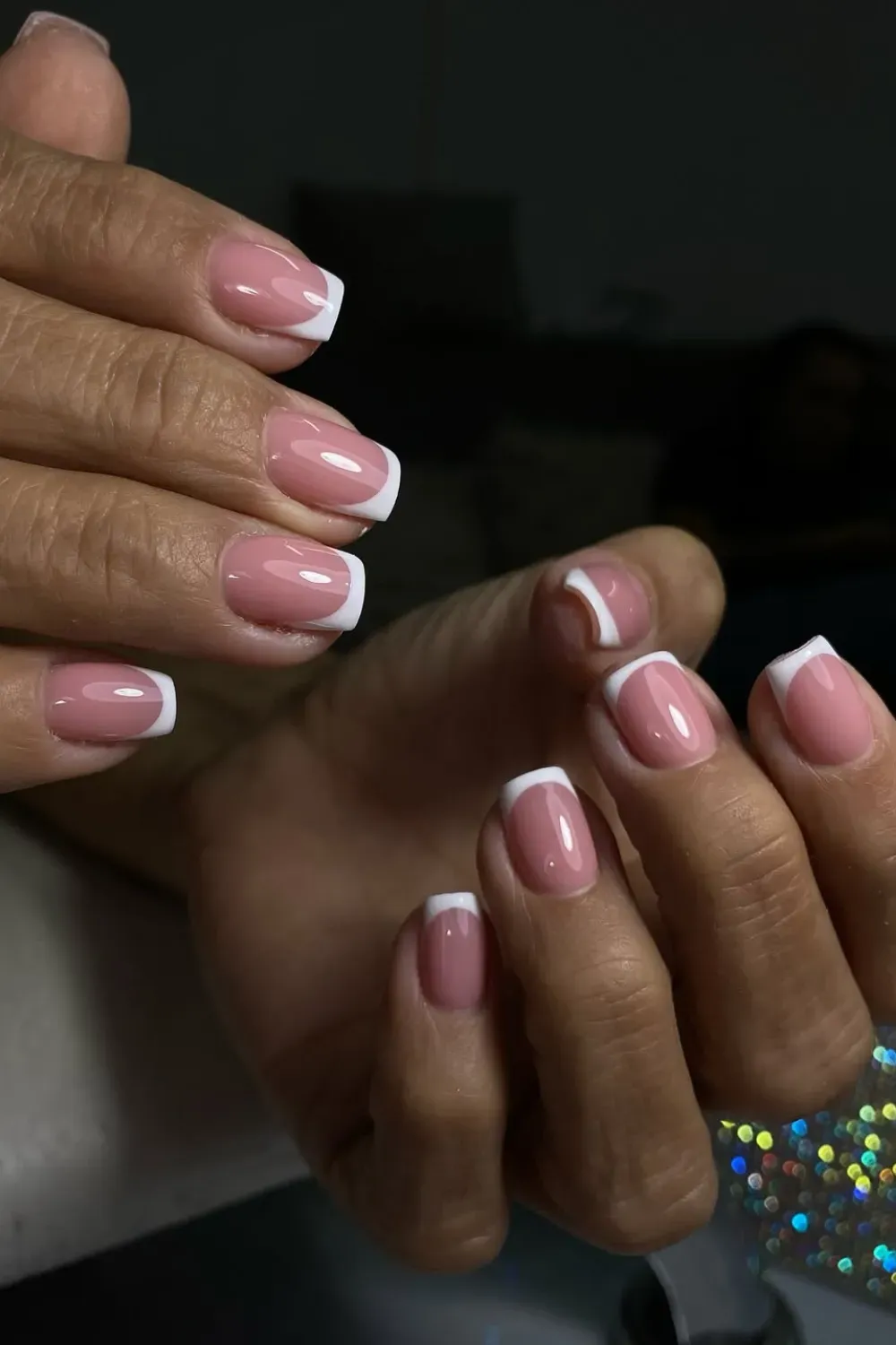  Short nails with a micro French manicure featuring thin white tips on a nude base for a modern, minimalist look.