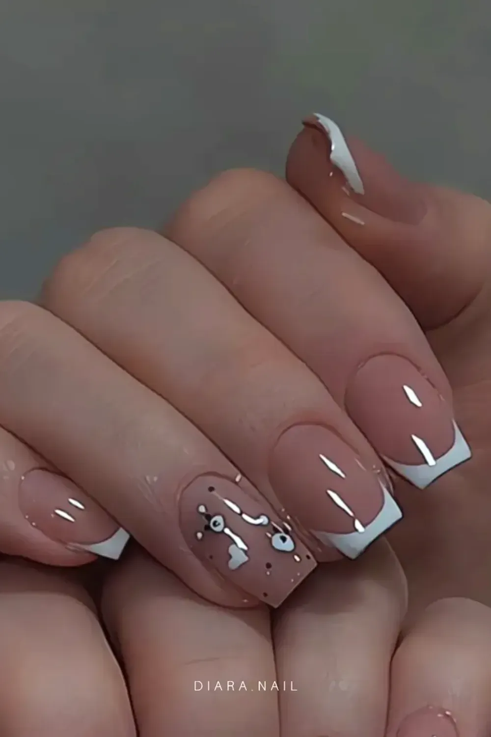 French Tips with Heart and Dot Design - Classic French tips with a playful heart and dot design on one nail, adding a fun and unique touch to the elegant look.